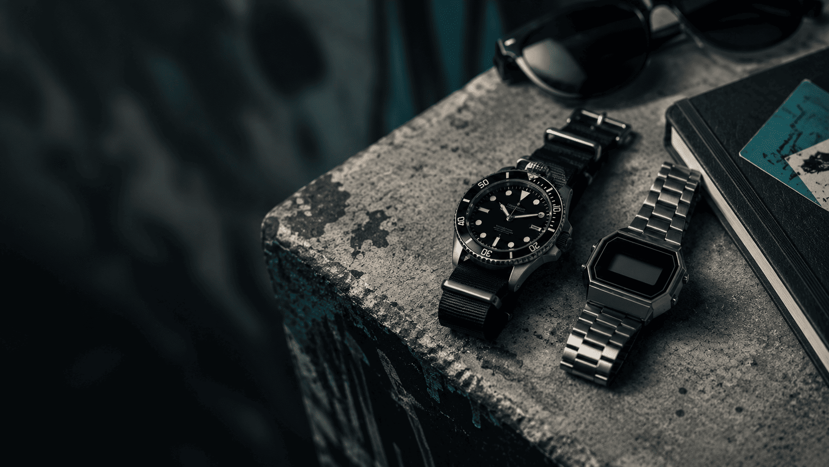 Affordable dive and digital watches on concrete with sunglasses